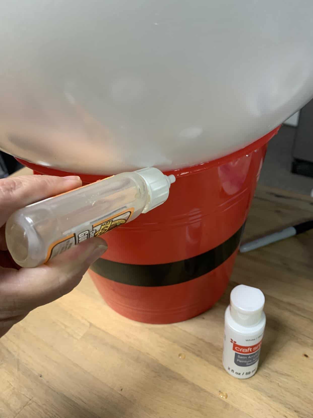 Glue the ball to the bucket